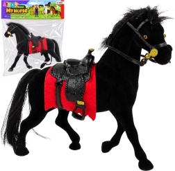 Velvet figurine of a black horse with a red saddle pad and saddle