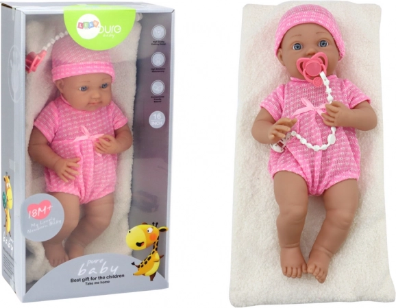Baby doll in a pink outfit with cap, pacifier, and blanket