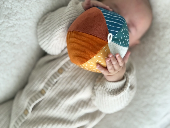 A rattle that encourages grasping