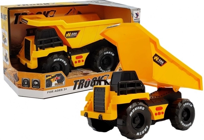 Yellow children's dump truck with friction drive, lights and sounds