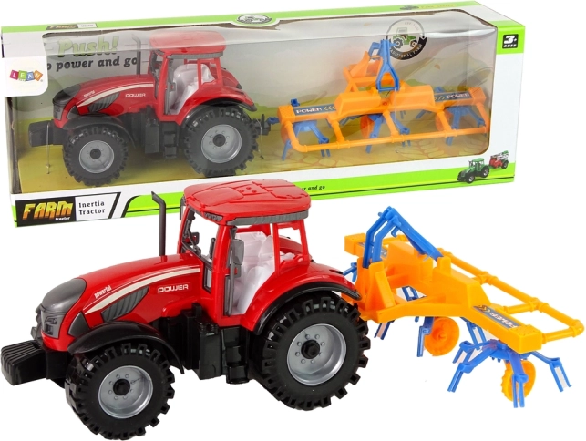 Red tractor with rake and friction drive